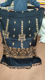 Women's black and gold shawl held open