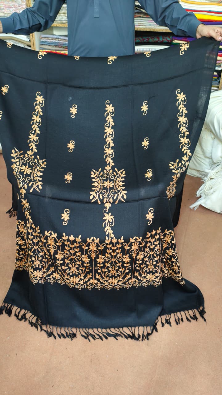 Women's black and gold shawl held open