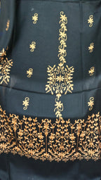 Close-up of gold botanical floral embroidery on black shawl